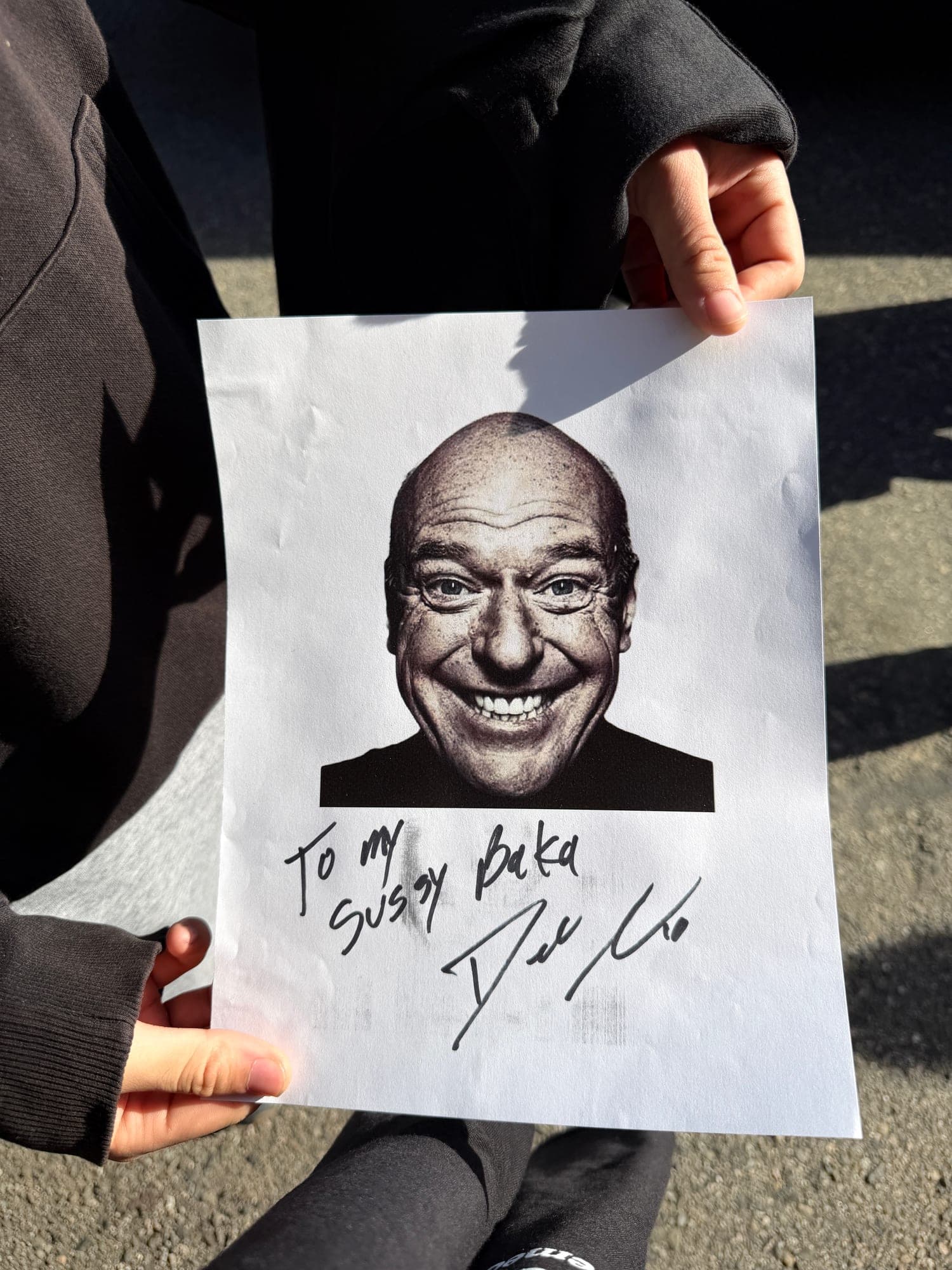 A signed black-and-white headshot inscribed "To my sussy baka"